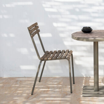 Refined Ethimo Laren chair with a muted gray metal frame and light natural wood slats, crafted in Italy