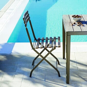 Distinguished Ethimo Laren folding chair with matte olive green metal and naturally-grained wood slats crafted in Italy