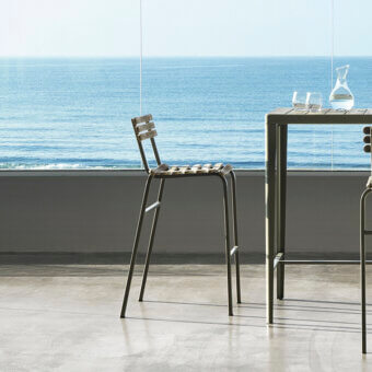 Superior Ethimo Laren stool with a matte dark gray metal frame and warm natural brown wood slats crafted in Italy