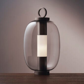 Elegant Ethimo Lucerna table lamp crafted in Italy with translucent glass and dark matte bronze-toned metal frame