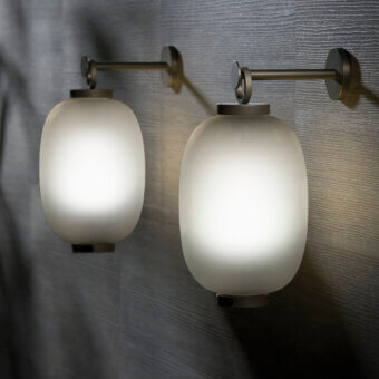 Distinguished Ethimo Lucerna wall lamp reimagines a Roman oil lamp with glass and muted-tone metal in a matte finish