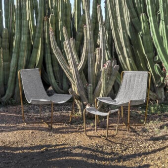 Distinguished Ethimo Sling lounge chair with a warm-toned brass metal frame and light grey woven textile finish