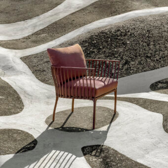 Elegant Ethimo Venexia lounge chair with a comfortably enveloping form upholstered in rose-toned textile and satin aluminum frame