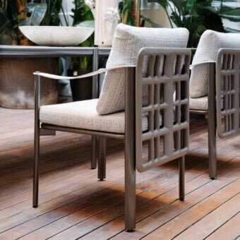 Superior Giorgetti Aldìa armchair with sleek metal frame and sculpted birch plywood details in light gray waterproof fabric