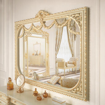 Lavish Modenese Golden Radiance shaped mirror crafted in wood with floral motifs and glossy gold finish