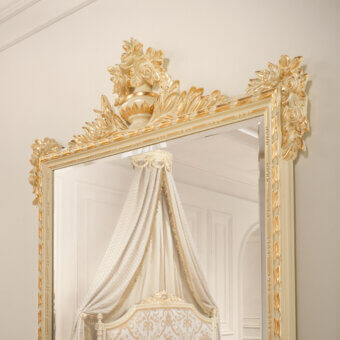 Distinguished Modenese Golden Radiance mirror crafted in Italy with an ornate, glossy golden wood frame and elaborate floral detailing