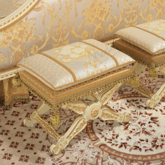 Lavish Modenese Golden Radiance ottoman with cream and gold damask fabric upholstery and a glossy carved wooden frame