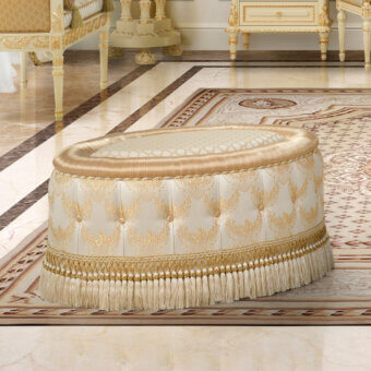 Lavish Modenese Golden Radiance oval ottoman crafted in cream and gold damask fabric with a subtly glossy finish and delicate fringe detailing