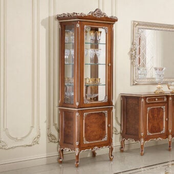 Distinguished Modenese Timeless Grace cupboard crafted with walnut finish and gold leaf detailing exhibiting a glass door and mirrored back
