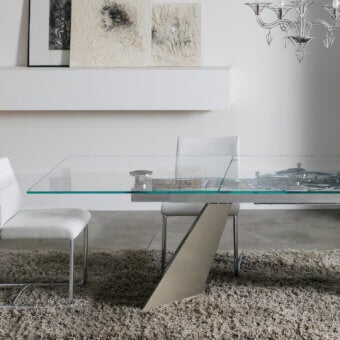 Sophisticated Naos Galax extendable dining table with clear glass, a chromed steel base, and teal painted central support leg