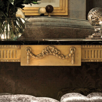 Lavish Provasi 0270 console built with black marble and a lacquered wood finish exhibiting gilded detailing