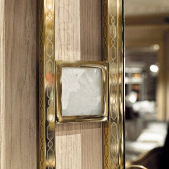 Lavish Provasi 1607 mirror with brass frame and integrated marble details in warm wood with polished gold geometric patterns