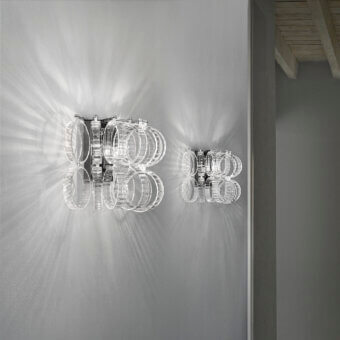 Distinguished Vistosi Ecos wall lamp crafted in polished metal with interlocking curvilinear elements and bright silvery tone