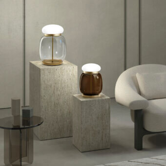 Elegant Vistosi Faro table lamp with clear and amber tinted glass plus a glossy white base and satin finish metal ring