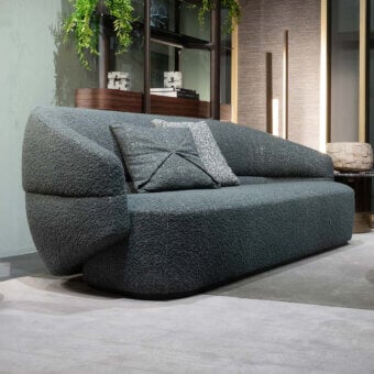 Distinguished Zanaboni Alma sofa crafted in textured bouclé weave with a muted dark gray-blue tone and refined grey stained ash wood base