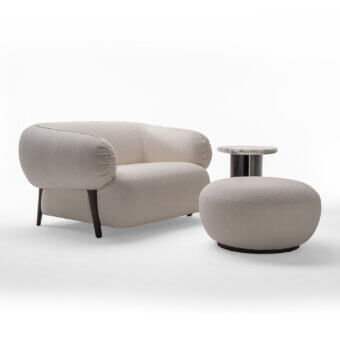 Superior Zanaboni Carol ottoman built with textured light beige bouclé and a dark encircling band