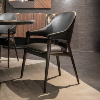 Distinguished Zanaboni Egle armchair crafted with sculptural solid wood and premium leather upholstery in deep charcoal with a satin finish