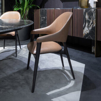 Captivating Zanaboni Egle armchair built with sculptural solid wood and premium leather in a warm medium-brown tone