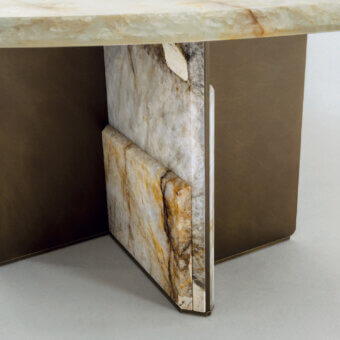 Distinguished Zanaboni Kalos table with a creamy beige marble tabletop exhibiting amber and white veining and a layered marble base built in brushed bronze-toned metal