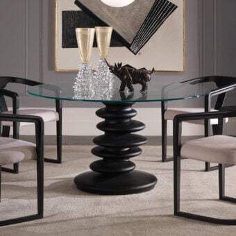 Distinguished Zanaboni Ometto table with a clear glass top and uniquely stacked, stone-inspired dark matte column base