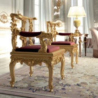 Lavish Armando Rho A1349 lounge chair crafted in burgundy upholstery with luminous gold leaf and ornate carvings