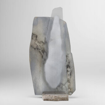 Exceptional Arte Veneziana Adriano mirror with extra-clear glass, mottled tones, travertine base and satin steel profile
