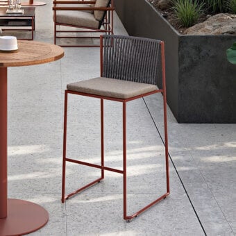 Distinguished Atmosphera Pipe stool with terracotta epoxy powder-coated steel, hand-woven acrylic rope backrest and bold geometry