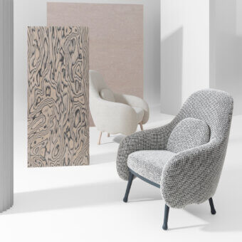 Distinguished Billiani Corolla lounge chair with grayscale patterned textile upholstery and worked wood base with dark gray metal legs