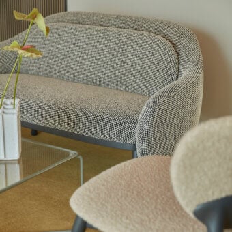 Distinguished Billiani Corolla sofa crafted in neutral beige textile with black speckles and a dark-toned wooden base