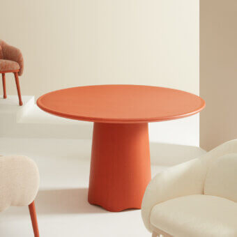 Elegant Billiani Corolla dining table in terracotta orange with worked wooden pedestal and smooth matte finish