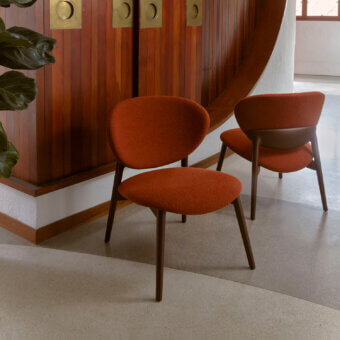 Exceptional Billiani Fleuron lounge chair with reddish-orange textile upholstery and dark satin-finished wood framing