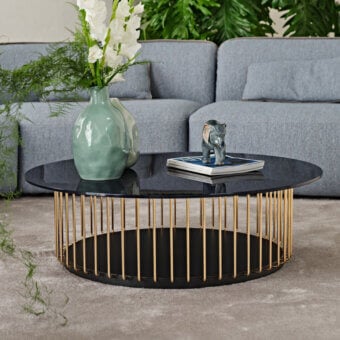 Architectural Black Tie Etan coffee table with back-lacquered glass tabletop and gold-toned metal rods enclosing black lacquered MDF