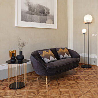 Distinguished Black Tie Etan side table with round top and slender gold-toned metal rod structure in lacquered MDF