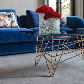 Elegant Black Tie coffee table crafted in Italy with glossy golden metal and sleek back-lacquered glass top