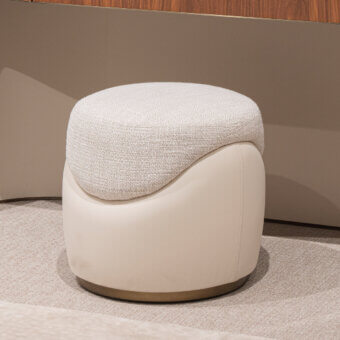 Distinguished Capital Clori ottoman with textured off-white fabric and smooth light beige material, accented by a refined metallic finish base