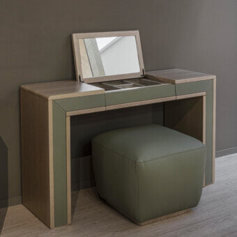 Elegant Carpanelli Galileo Lux vanity crafted in light neutral wood with muted olive green drawers and a cushioned stool in satin finish