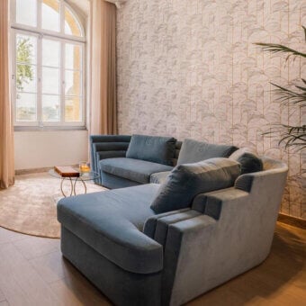 Sophisticated Carpanelli Theater sectional with plush textile upholstery and refined metal base construction
