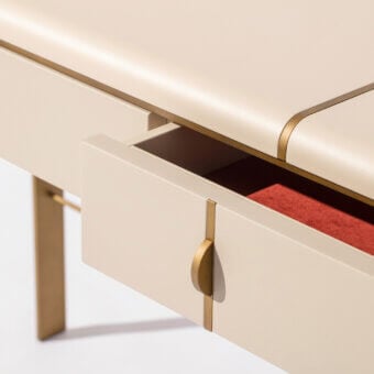 Exceptional Carpanese Home Althea C console built with pale beige synthetic surface and satin brass metal inlays offering refined storage