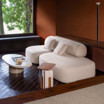 Distinguished Carpanese Home Slow sofa with light beige textured textile upholstery and elegantly exposed ash wood supports