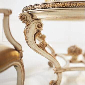 Superior Faber Mobili Ortensia table crafted with gilded wood, a glass top, and intricate scrolling foliage in an off-white finish