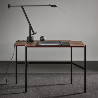 Distinctive Frag Arita desk table crafted in medium-dark satin-finish wood with a black metal leg structure and burnished brass caps