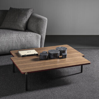Superior Frag Arita coffee table built with wood and painted steel, exhibiting soft curves with burnished brass legs and a satin sheen