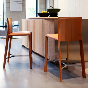 Captivating Frag Blyn bar stool with full saddle leather upholstery and warm, brushed metal frame