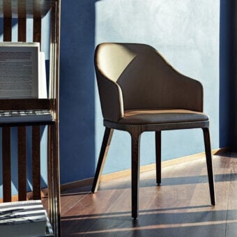 Distinguished Frag Doa dining chair with padded shell in muted taupe fabric and satin finished exposed ash wood frame