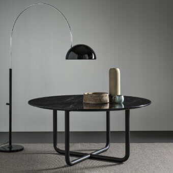 Elegant Dainelli Studio Frag Paipu dining table with a glossy polished marble top and matte black steel base