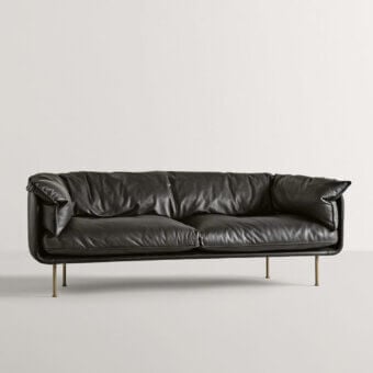 Superior Frag Winnie sofa upholstered in lavish black leather with a subtle matte finish and slender gold-toned legs