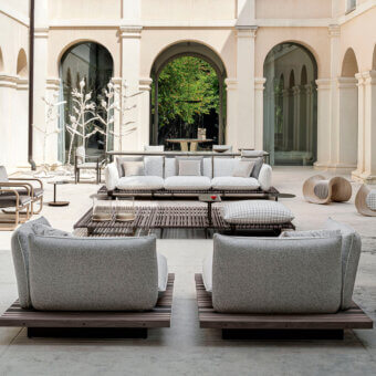 Elegant Giorgetti Apsara lounge chair with carob powder-coated aluminum, Afrormosia wooden slats, and waterproof outdoor technical fabric upholstery