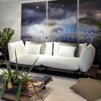 Sophisticated Giorgetti Apsara sofa crafted with carob powder-coated aluminum, Afrormosia wooden slats, white waterproof fabric and olive green cushions
