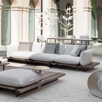 Distinguished Giorgetti Apsara sofa built with carob powder-coated aluminum, Afrormosia wooden slats, and waterproof outdoor technical fabric cushions