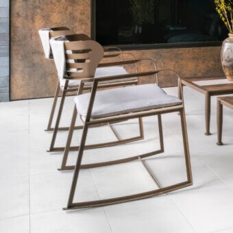 Exceptional Giorgetti Gea rocking lounge chair with a geometric stainless steel frame in carob finish and neutral beige birch cushions